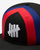 FA26 UNDEFEATED X NE STRIPE SNAPBACK - BLACK