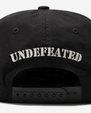 UNDEFEATED FA25 SLOUCHY 5 PANEL SNAPBACK - BLACK