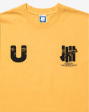 UNDEFEATED COMM S/S TEE MARIGOLD