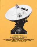 UNDEFEATED COMM S/S TEE MARIGOLD