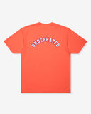 UNDEFEATED SP26 EMBLEM S/S TEE-CORAL