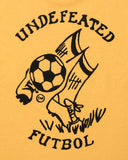 UNDEFEATED FUTBOL S/S TEE MARIGOLD