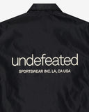 UNDEFEATED SP26 INC. COACHES JACKET - BLACK