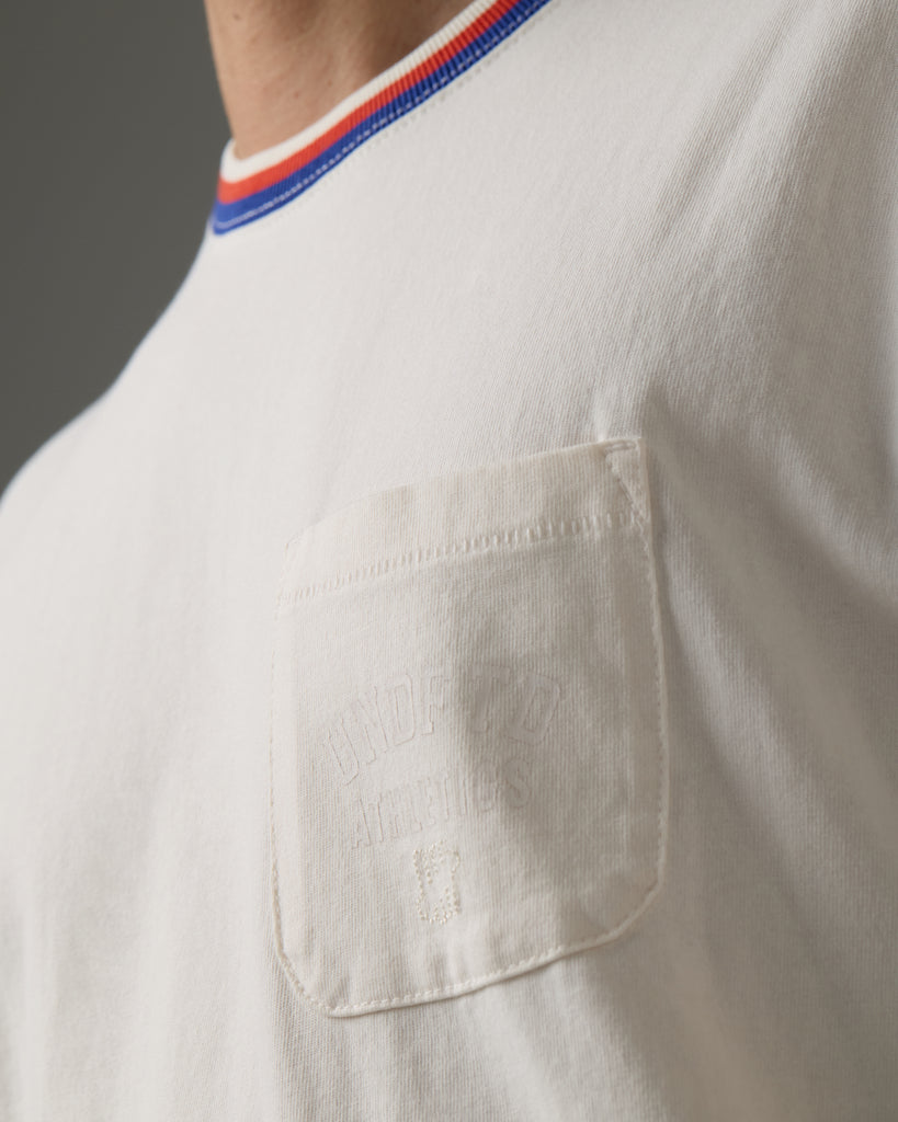 UNDEFEATED SU26 RINGS S/S POCKET TEE - OFFWHITE