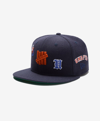 UNDEFEATED HO25 X NEW ERA ALL OVER FITTED - NAVY