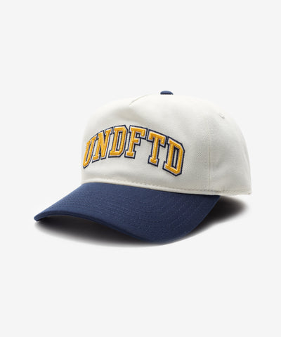 UNDEFEATED 2 TONE ARCH SNAPBACK IVORY NAVY