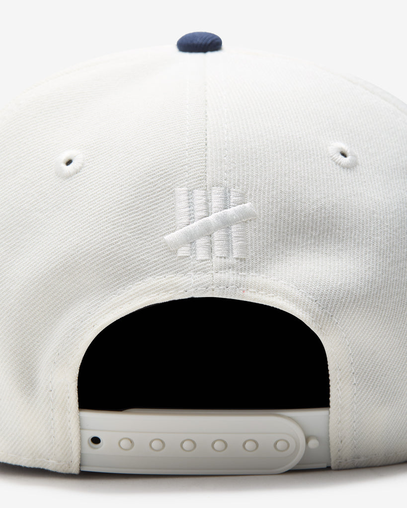 UNDEFEATED 2 TONE ARCH SNAPBACK IVORY NAVY