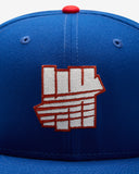 UNDEFEATED SU26 X NE ICON CREST FITTED - BLUE