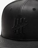 UNDEFEATED SP26 X NE LEATHER ICON FITTED - BLACK