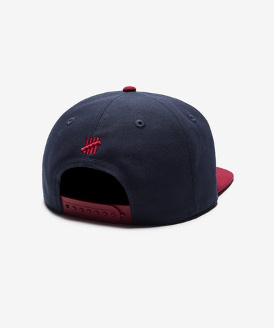 UNDEFEATED SP26 PLAY DIRTY SNAPBACK - NAVY