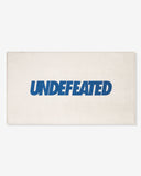 UNDEFEATED SU26 LOGO BEACH TOWEL- CREAM