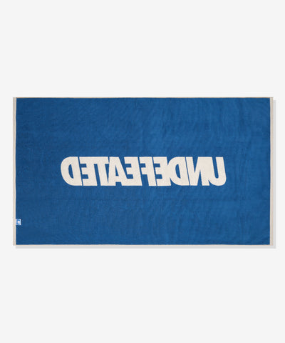 UNDEFEATED SU26 LOGO BEACH TOWEL- CREAM