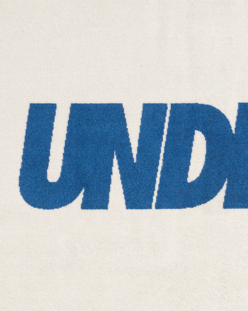 UNDEFEATED SU26 LOGO BEACH TOWEL- CREAM