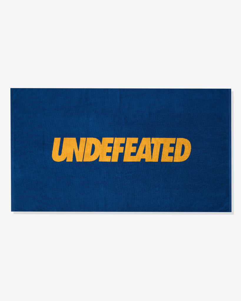 UNDEFEATED SU26 LOGO BEACH TOWEL- ROYAL BLUE