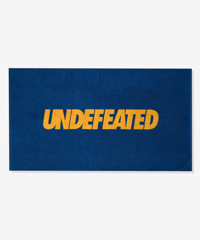 UNDEFEATED SU26 LOGO BEACH TOWEL- ROYAL BLUE