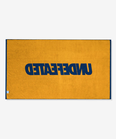 UNDEFEATED SU26 LOGO BEACH TOWEL- ROYAL BLUE