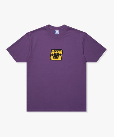 SU26 UNDEFEATED BADGE S/S TEE - PURPLE