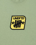 SU26 UNDEFEATED BADGE S/S TEE - SAGE