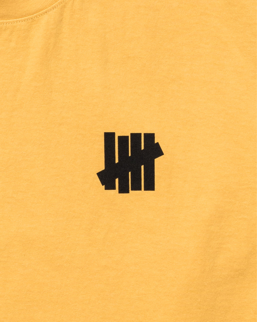 UNDEFEATED BLACKTOP L/S TEE MARIGOLD