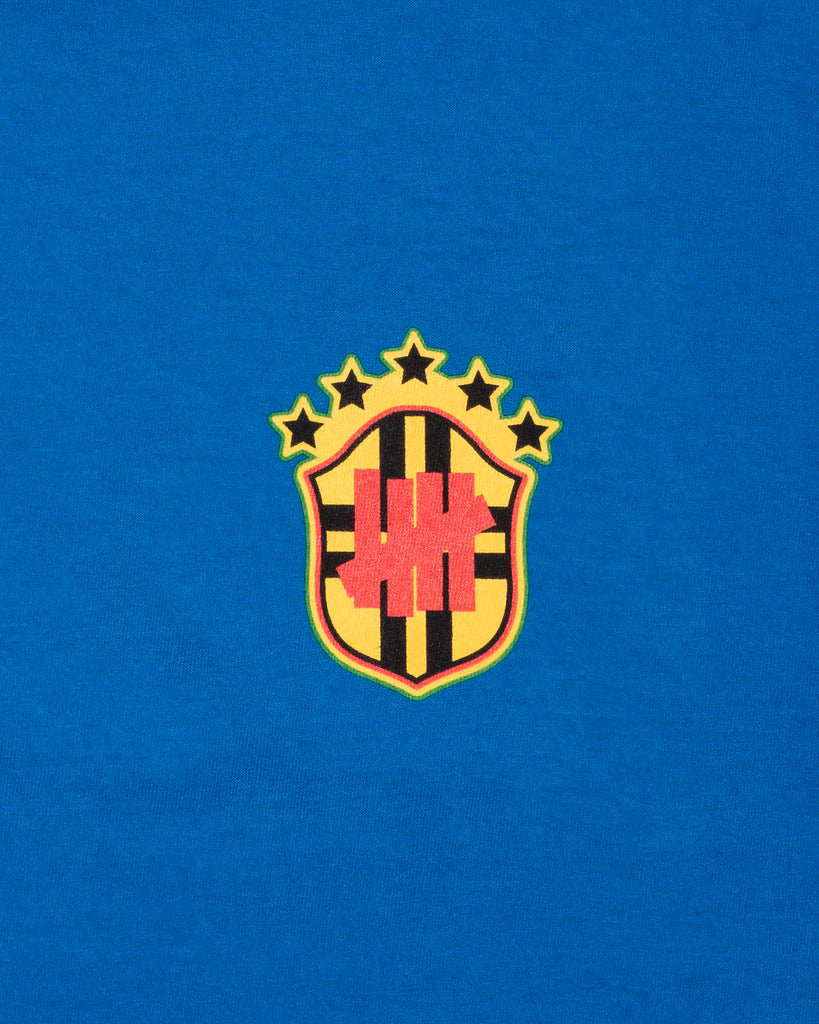 UNDEFEATED SP26 EMBLEM S/S TEE-BLUE