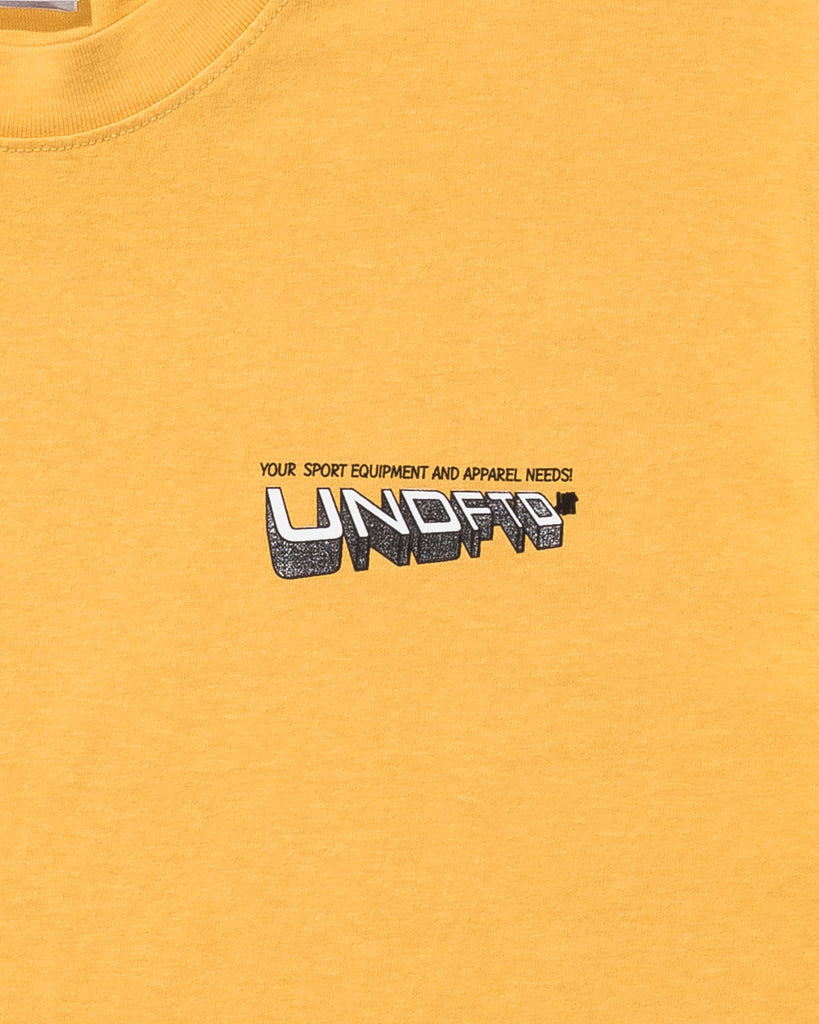 UNDEFEATED TEAM STORE S/S TEE MARIGOLD