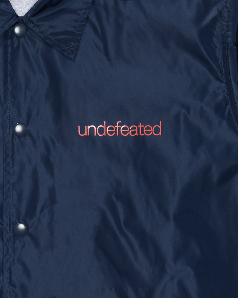 UNDEFEATED SP26 INC. COACHES JACKET - NAVY