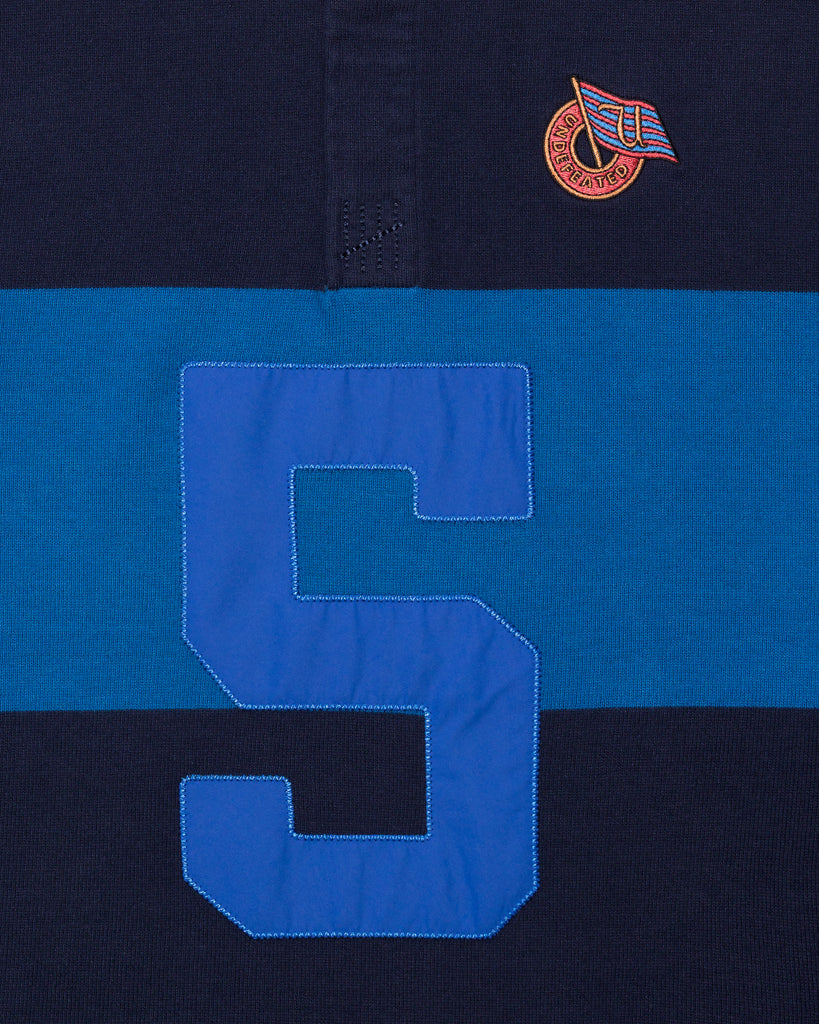FA26 UNDEFEATED STRIPED L/S RUGBY - BLUE